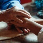 Compassionate hands conveying empathy in assisted dying debate – UK context